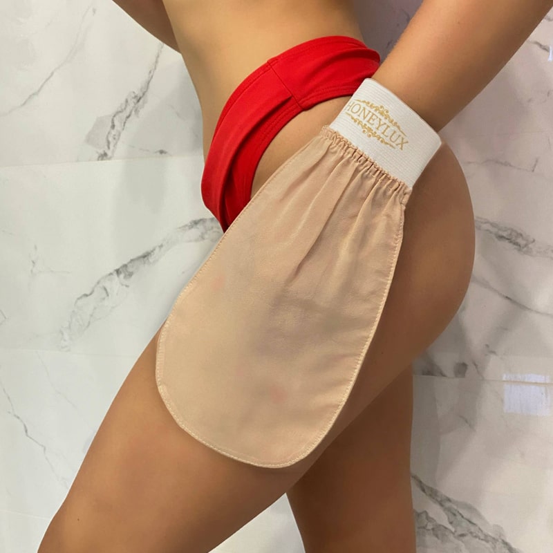 HoneyLux Turkish Silk Exfoliating Mitt - Body & Face - on model's hand being applied to upper leg