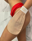 HoneyLux Turkish Silk Exfoliating Mitt - Body & Face - on model's hand being applied to upper leg