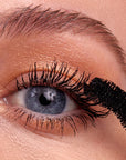 Kosas Cosmetics The Big Clean LONGWEAR Volumizing + Lash Care Mascara - showing model applying mascara to lashes