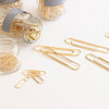 Studio Carta Gold Paper Clips showing multiple jars and some spilled out