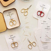 Studio Carta Le Piccole Scissors - pictured in tin (as received) along with multiple pairs and one with red handles (not included)