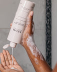 Neom Organics Super Shower Power Body Cleaner pouring on model hands 