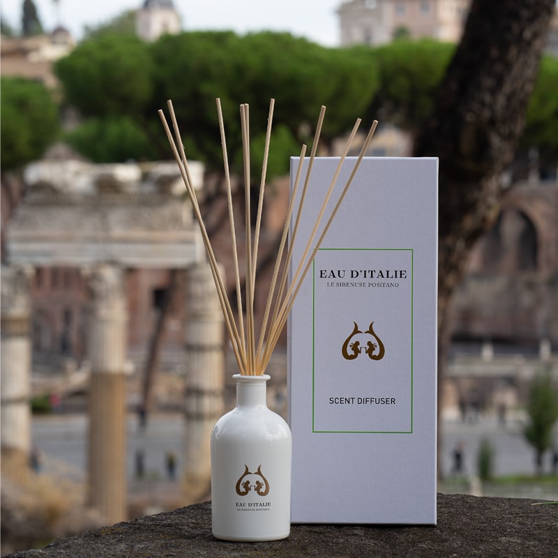 Lifestyle shot of Eau d’Italie Signature Scent Diffuser (240 ml) with box and ruins in the background