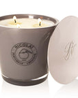 Parfums de Nicolai Maharadjah Candle shown with lid to the side and all 3 wicks lit