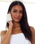 Daily Concepts Daily Slip-On Exfoliator showing model with pad on her hand touching her face