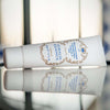 Santa Maria Novella Idralia Essence beauty shot of tube lying on reflective table