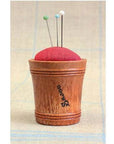 Sajou Wooden Pin Cushion – Red Linen shown with pins sticking in it (not included)