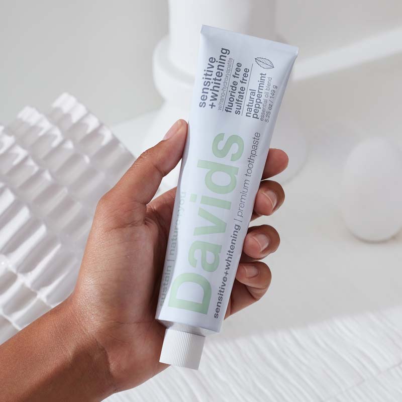 Davids Premium Toothpaste - Sensitive + Whitening Nano-Hydroxyapatite in model's hand