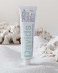 Davids Premium Toothpaste - Sensitive + Whitening Nano-Hydroxyapatite beauty shot in front of salt 