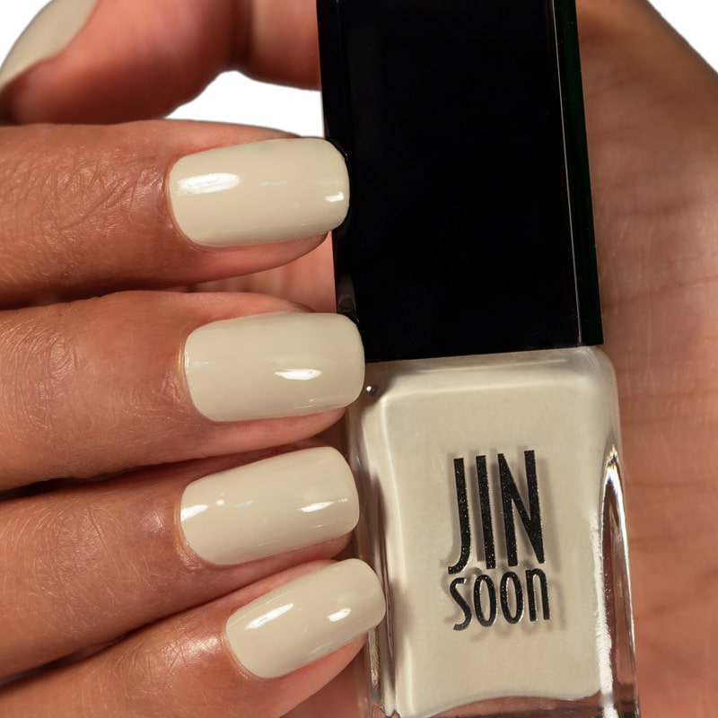 JINsoon x Suzie Kondi Nail Lacquer – Piedra in model&#39;s hands with model&#39;s nails painted with this polish
