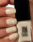 JINsoon x Suzie Kondi Nail Lacquer – Piedra in model's hands with model's nails painted with this polish
