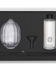 Diptyque Roses Home Fragrance Diffuser showing box open with diffuser bottle, fragrance container, funnel and reeds in box