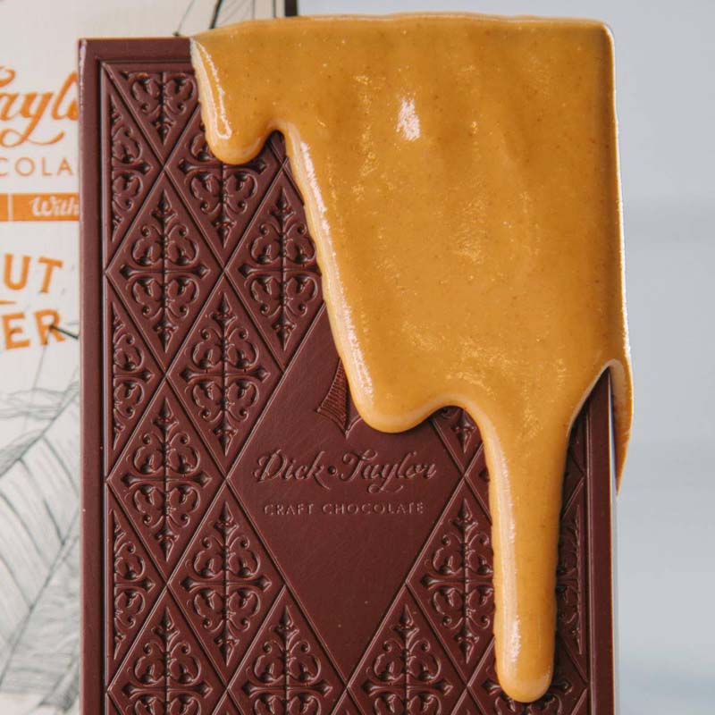 Dick Taylor Craft Chocolate Peanut Butter Dark Chocolate - beauty shot showing close-up of chocolate dripping down over top of bar