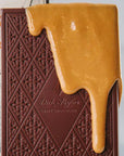 Dick Taylor Craft Chocolate Peanut Butter Dark Chocolate - beauty shot showing close-up of chocolate dripping down over top of bar