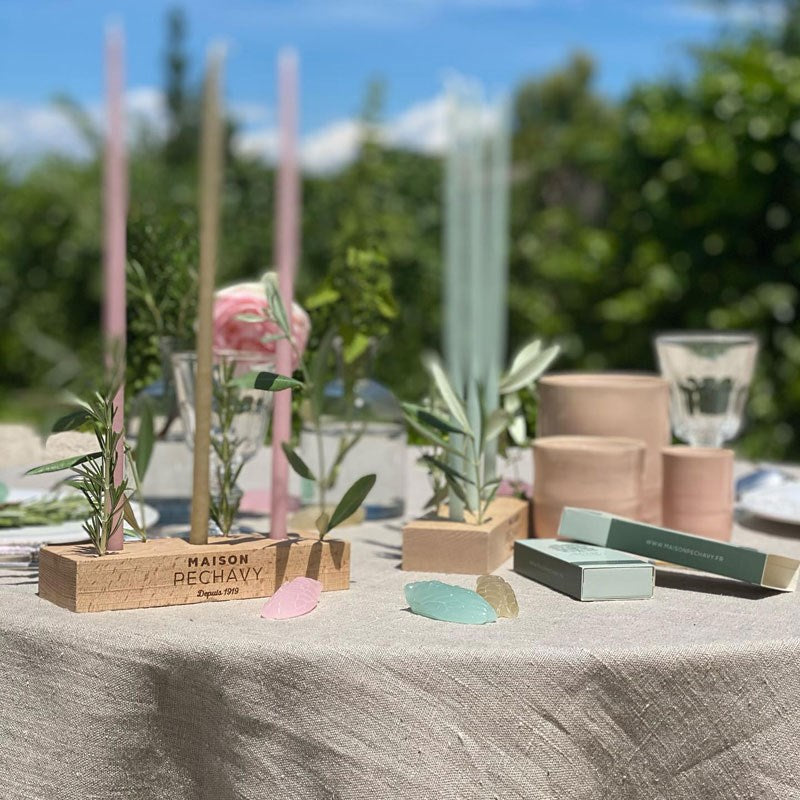 Maison Pechavy Wooden Candle Holder - lifestyle shot with a couple of candle holders with various colored candles on a celebratory table.