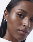 (M)ANASI 7 Strobelighter Radiant Finish – Heliconia shown on dark skin model's face