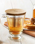 La Rochere Bee Tea Infuser Mug - lifestyle shot showing mug with tea in it and toast with honey in background