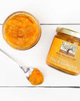 Frog Hollow Farm Organic Peach Conserve showing jar opened with spoon full