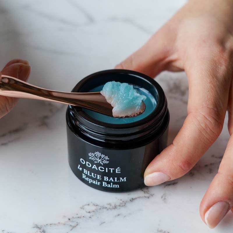 Odacite Le Blue Balm showing a spoon scooping balm.