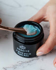 Odacite Le Blue Balm showing a spoon scooping balm.