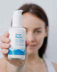 Ursa Major Making Moves Milky Cleanser with blurred model holding product