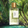 Mood shot of Goldfield & Banks Bohemian Lime Perfume 100 ml with water and palm trees in the background