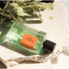Goldfield & Banks Blue Cypress Perfume shown with plant and stone