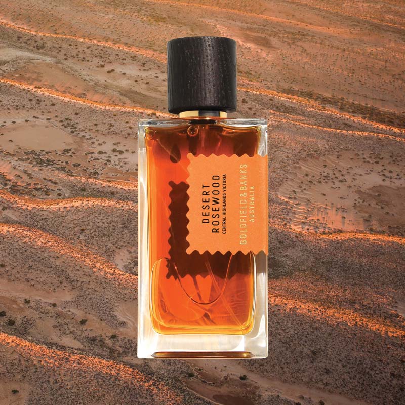 Mood shot of Goldfield &amp; Banks Desert Rosewood Perfume 100 ml with desert landscape in the background