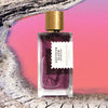 Mood shot of Goldfield & Banks Southern Bloom Perfume 100 ml with pink water in the background and dried landscape