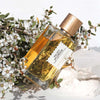 Lifestyle shot of Goldfield & Banks Velvet Splendour Perfume 100 ml on stone slab with white flowers in the background