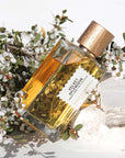 Lifestyle shot of Goldfield & Banks Velvet Splendour Perfume 100 ml on stone slab with white flowers in the background