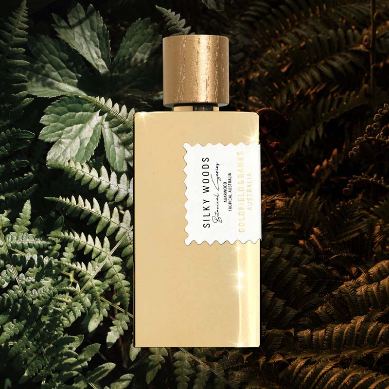 Mood shot of Goldfield & Banks Silky Woods Perfume 100 ml with ferns in the background