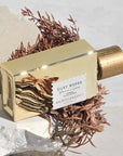 Beauty shot of Goldfield & Banks Silky Woods Perfume 100 ml on stone slab with botanical element in the background
