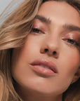 Roen Beauty Kiss My Lip Balm – Remi shown on model with medium tone skin