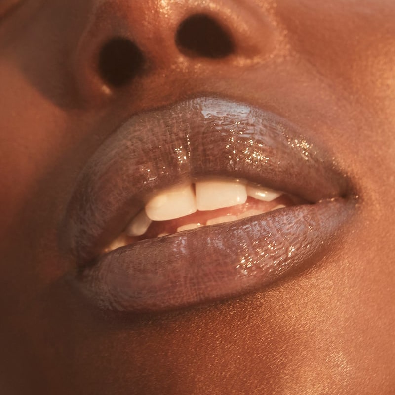 Close up of Roen Beauty Kiss My Lip Balm – Remi shown on model with dark tone skin