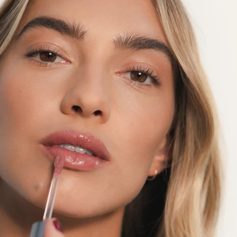 Model applying Close up of Roen Beauty Kiss My Lip Balm – Charlie (3 ml) on lips