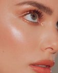 Roen Beauty Roglow Skin Stick Highlighter – Glazed showing on cheek