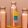 Tamra Copper LA Tamra Tassels: Orchid Trio showing hanging from copper bottle