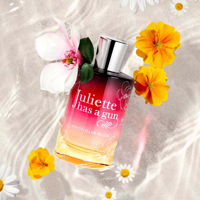 Juliette Has A Gun Magnolia Bliss Eau de Parfum shwoing sitting in water and sand with flowers 