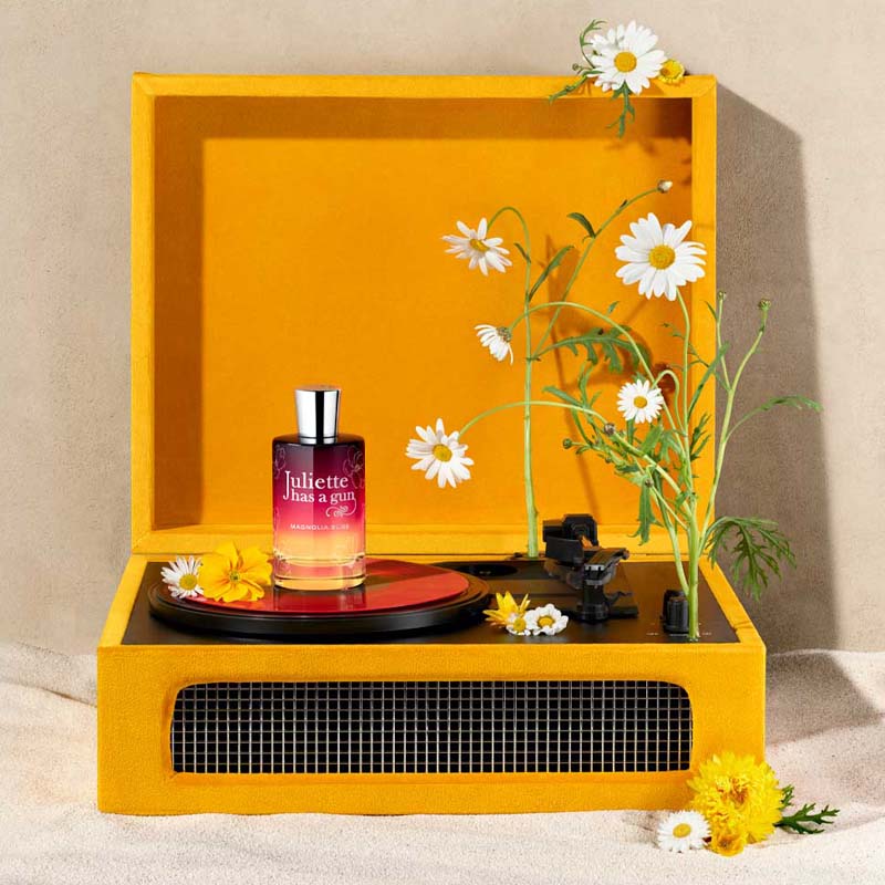 Juliette Has A Gun Magnolia Bliss Eau de Parfum showing on an orange record player with flowers