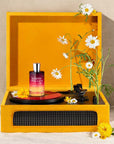 Juliette Has A Gun Magnolia Bliss Eau de Parfum showing on an orange record player with flowers
