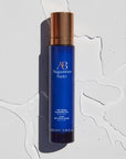 Lifestyle shot top view of Augustinus Bader The Cream Cleansing Gel (100 ml) with water in the background