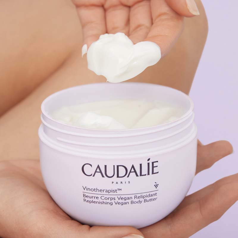 Caudalie Vinotherapist Replenishing Vegan Body Butter showing model scooping out product
