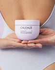 Caudalie Vinotherapist Replenishing Vegan Body Butter showing model holding product in hands behind back