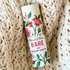 Stewart & Claire Bare Unscented Lip Balm with Rosehip Seed Oil showing on a knitted blanet