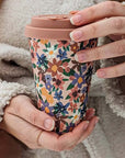 Mimi & August Floral Bouquet Cafe Yo Cup showing model holding cup