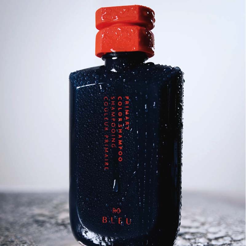 R+Co Bleu Primary Color Shampoo showing with water drops on product