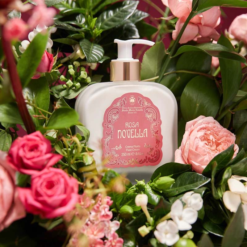 Santa Maria Novella Rosa Novella Fluid Body Cream showing surrounded by pink flowers