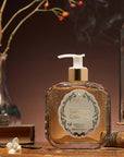 Santa Maria Novella Tabacco Toscano Liquid Soap showing on a counter with smoke in the background