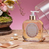 Santa Maria Novella Rosa Gardenia Liquid Soap sitting on a counter with a ribbon and pearls